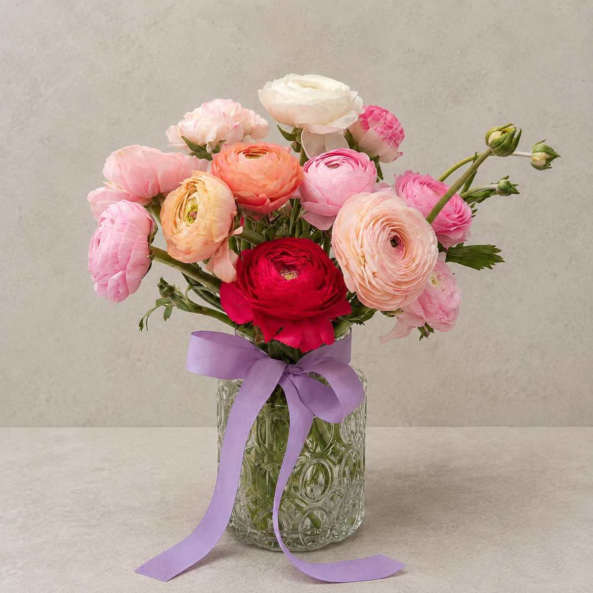 Five Acre Florets Ranunculus Vase - mixed pink, peach and red ranunculus in a glass vase with lilac ribbon